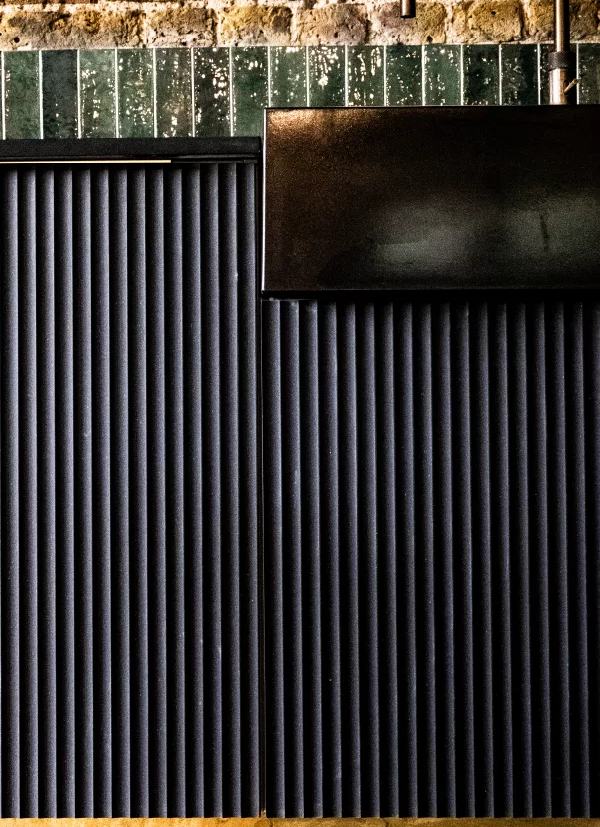 Black kitchen cabinet details with copper strip