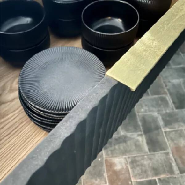 stocked kitchen draw with black tableware